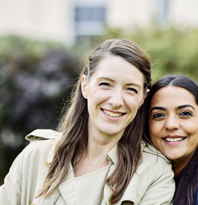 Two students smiling together