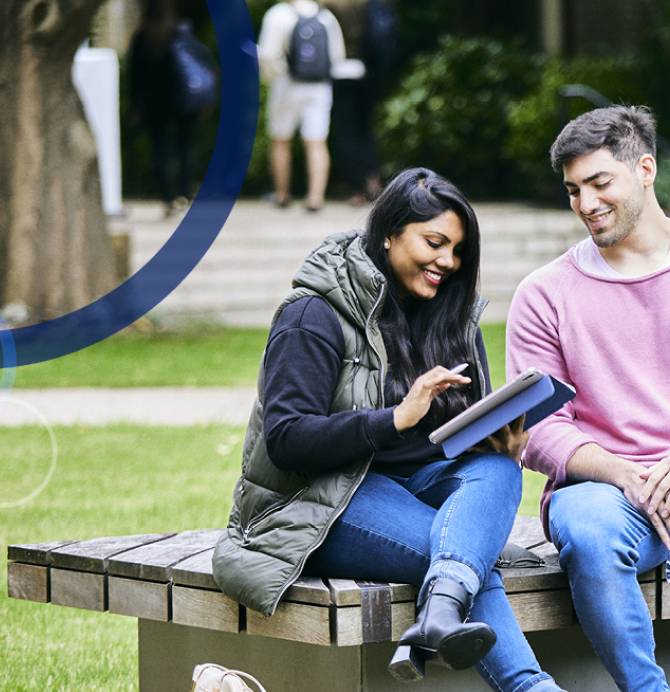 Two students sitting on a bench