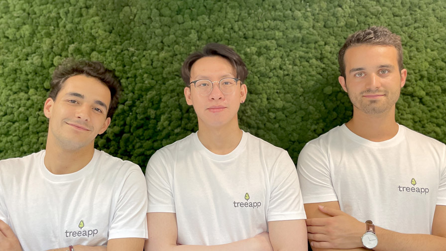 Image of three males on laying on the grass looking to camera.