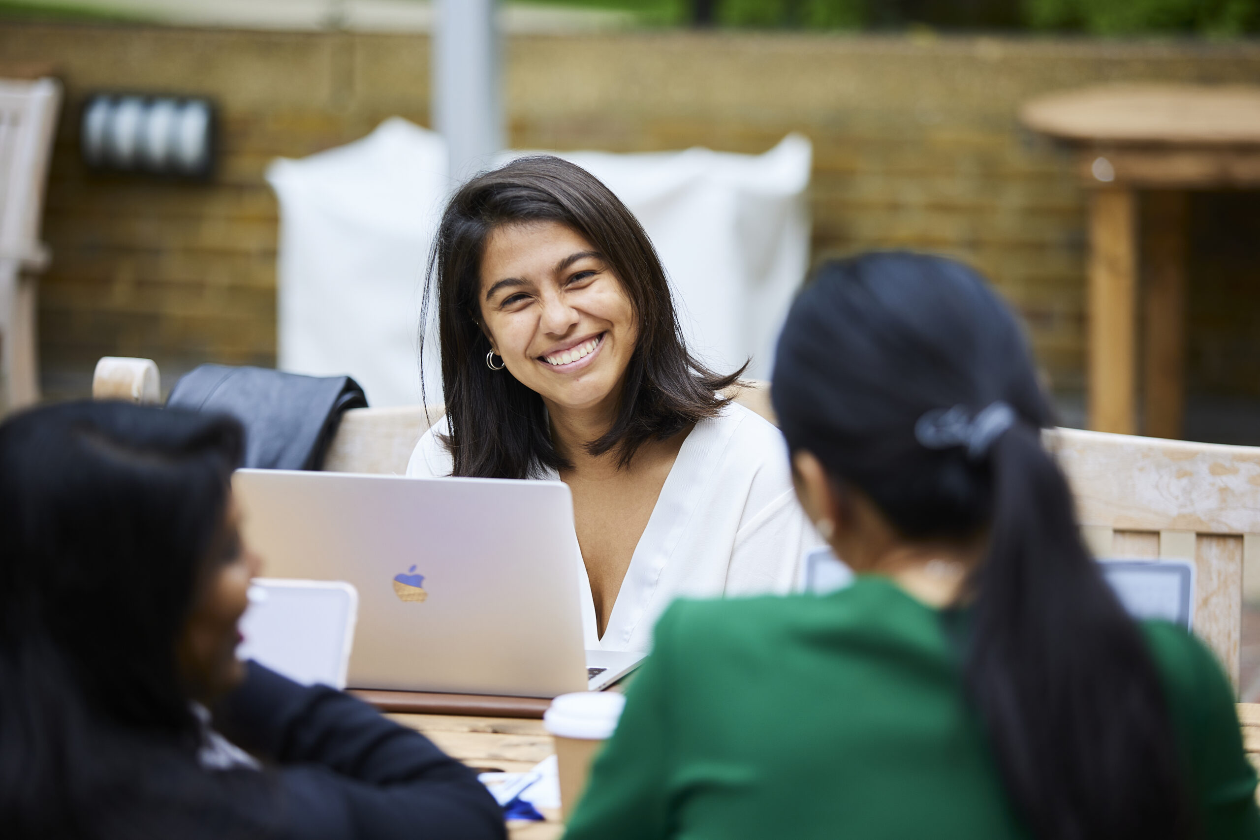 Smiling lady sat in front of her laptop