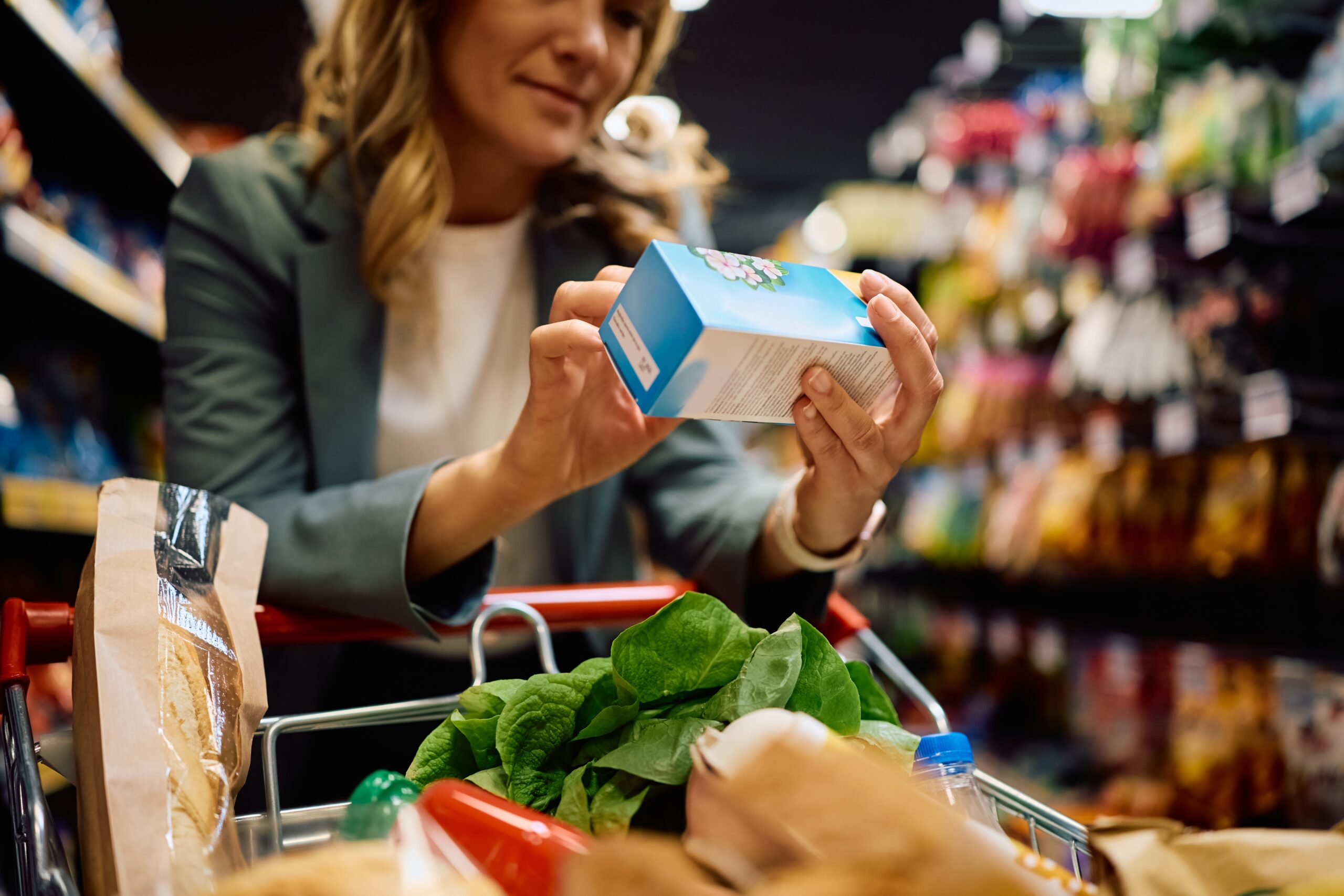 Close,Up,Of,Woman,Reading,Label,On,A,Package,While